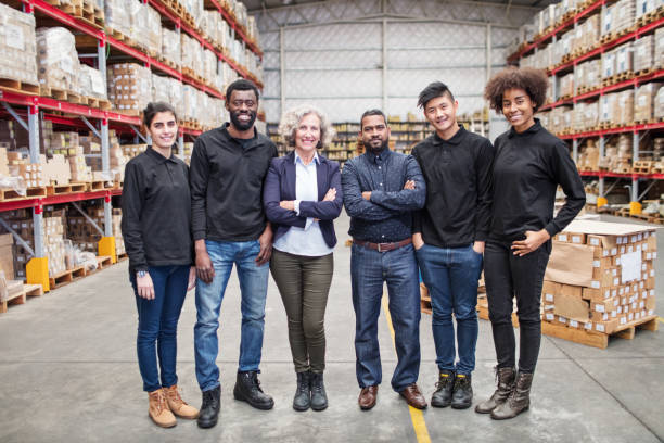 Portrait of successful logistics team Portrait of successful logistics team standing together. Senior manager with warehouse workers. manufacturing occupation photos stock pictures, royalty-free photos & images