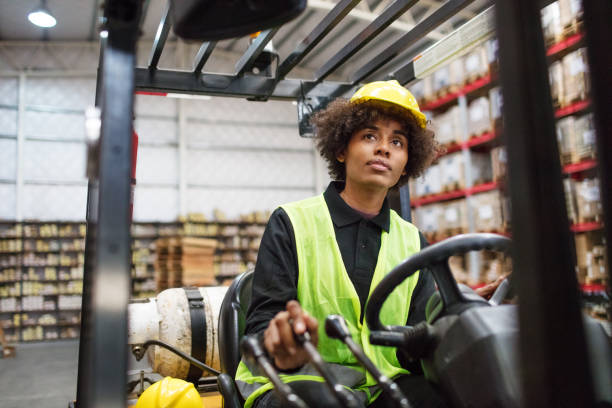 istock Woman operating a forklift loader in warehouse 1088912460