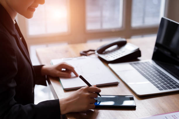istock Attractive asian female accountant using calculator app and discussing financial reports.finance accounting concept 1088914000