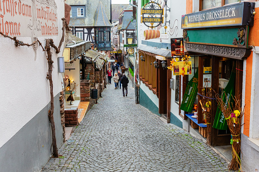 Ruedesheim am Rhein, Germany April 05, 2018: famous Drosselgasse with unidentified people. The Drosselgasse with old wine taverns becomes visited by about 3 millions tourists a year