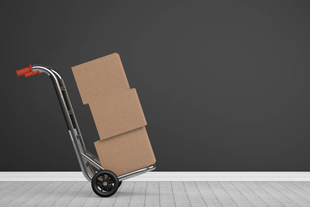 Moving House concept. Cardboard Boxes and Hand Truck in new room.