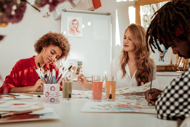istock Two beautiful women and one man attending painting classes 1088920558