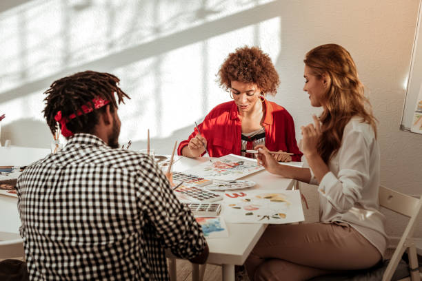 istock Team of three talented inspired artists drawing together 1088920580