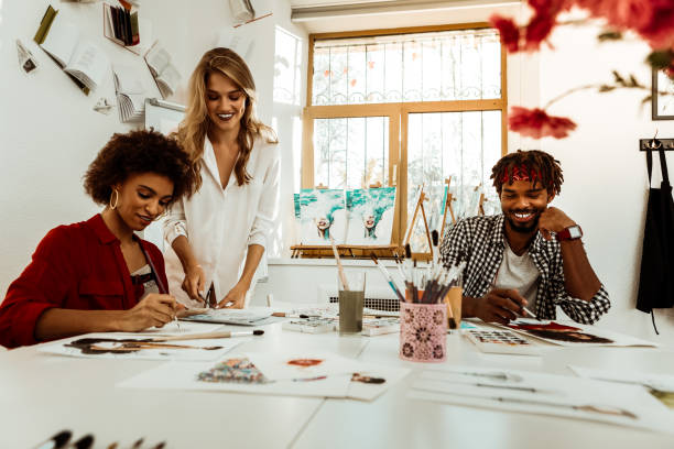 istock Two cheerful beaming art students listening to their teacher 1088920620