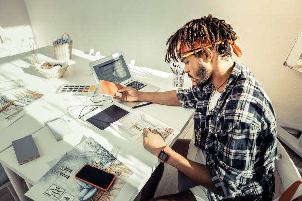 istock Bearded interior artist choosing suitable colors for his new project 1088920890