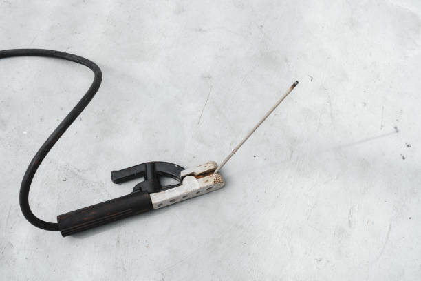 old electrode holder with covered electrode on concrete floor