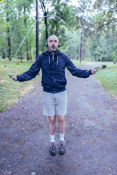 istock Mid Aged Man Exercising in Public Park 1088926806