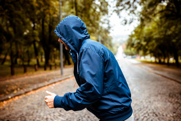 istock Man Jogging on a Rainy Day in the Park 1088927268