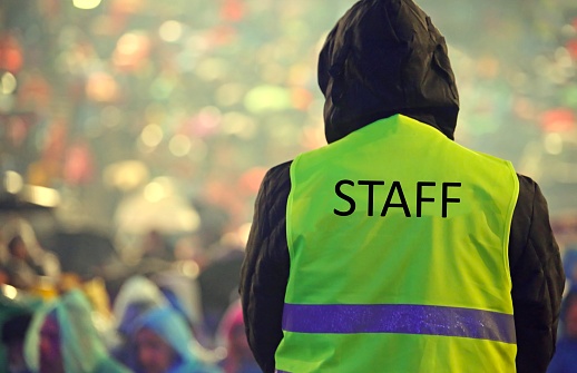 staff guard with the phosphorescent vest at the outdoor concert and during a storm
