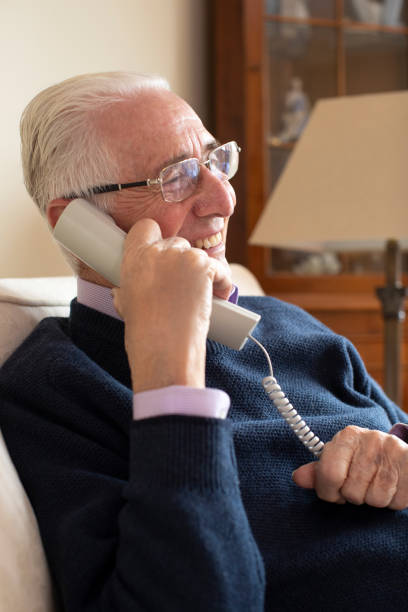 istock Smiling Senior Man Using Phone At Home 1088937570