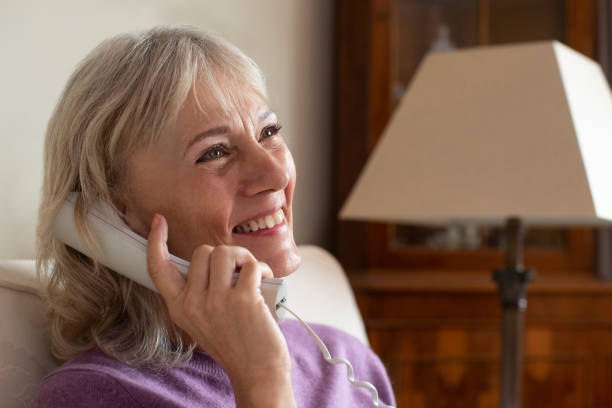 istock Smiling Senior Woman Using Phone At Home 1088937614