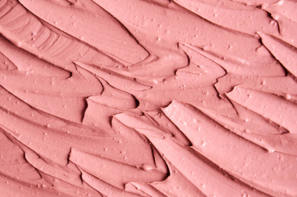 istock Soft pink cosmetic clay (facial mask, cream) texture close up, selective focus. Abstract background with brush strokes. 1088940048