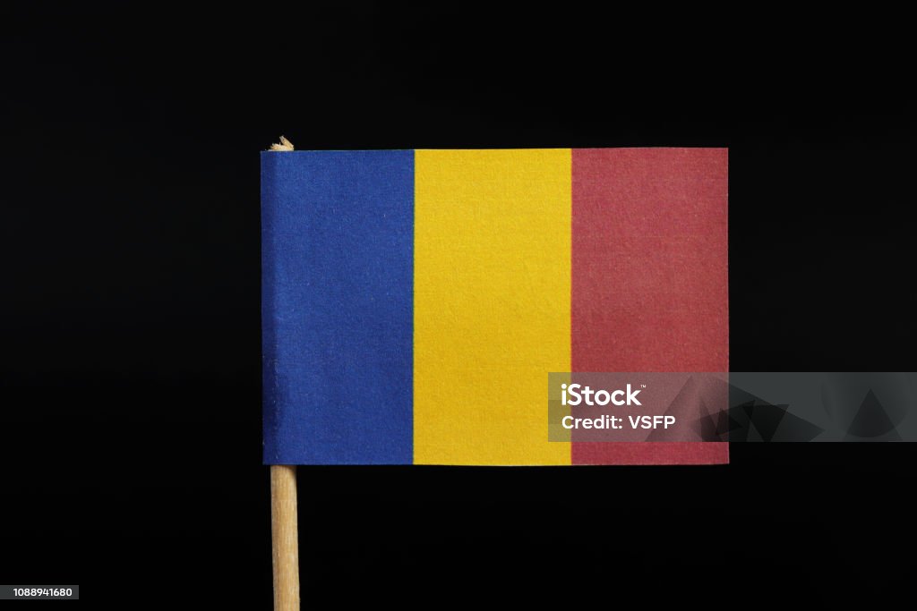 A national flag of Romania on toothpick on black background. A vertical tricolor of blue, yellow, and red A national flag of Romania on toothpick on black background. A vertical tricolor of blue, yellow, and red. Ancient Civilization Stock Photo