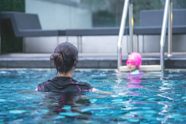 istock Mother is teaching her daughter to swim 1088942358