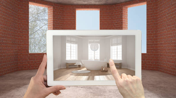 istock Augmented reality concept. Hand holding tablet with AR application used to simulate furniture and design products in an interior construction site, classic bathroom with bathtub 1088952010