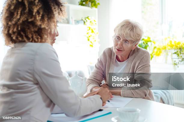 Senior Woman Talking With Insurance Advisor Stock Photo - Download Image Now - Assistance, Diabetes, Law