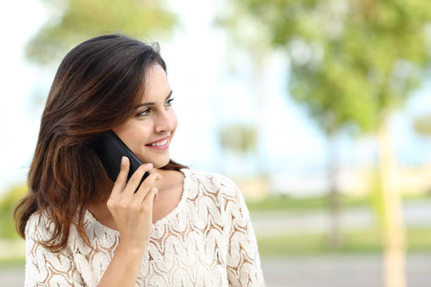 istock Happy woman talking on phone looking away 1088954996