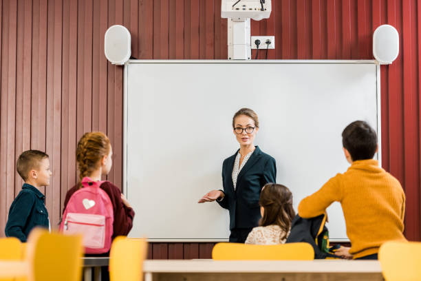 istock young teacher making presentation to cute schoolkids with backpacks 1088956244