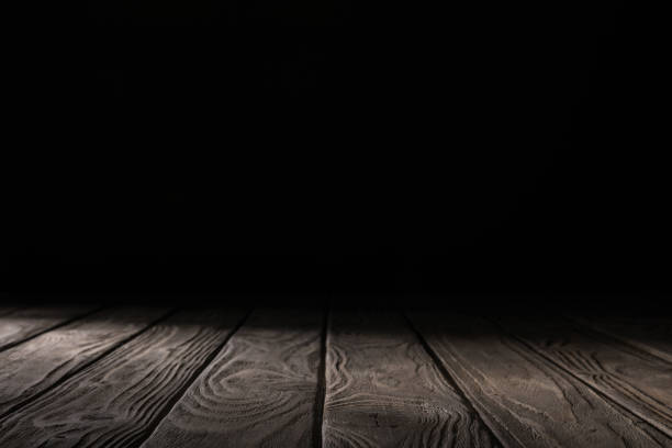 istock brown striped wooden tabletop on black 1088958312