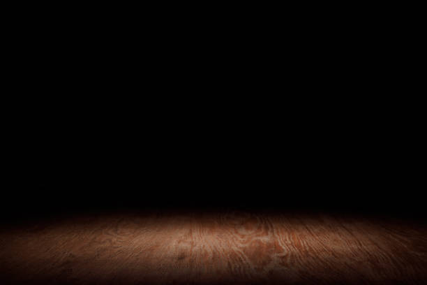 istock brown striped wooden tabletop on black 1088958356