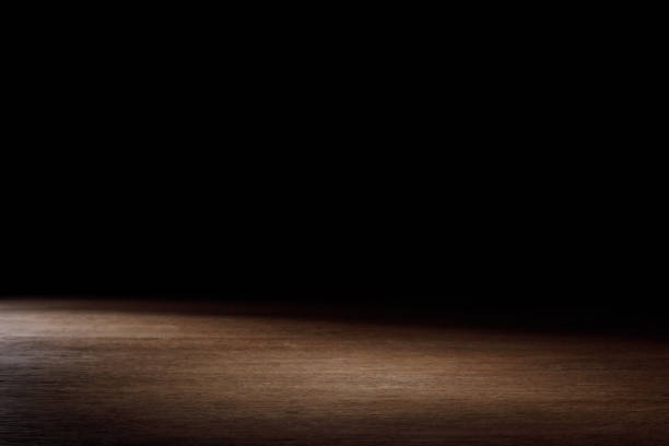 istock dark brown striped hardwood on black 1088958364