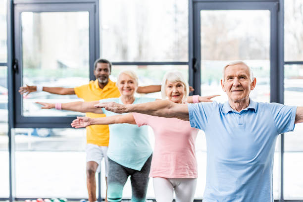 istock multicultural senior athletes synchronous doing exercise at gym 1088958450