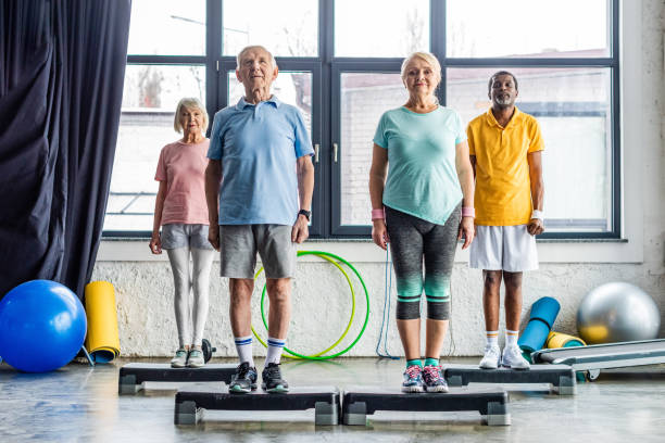 istock multiethnic senior athletes synchronous exercising on step platforms at gym 1088958502