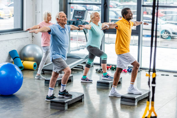 istock selective focus of senior multicultural athletes synchronous exercising on step platforms at gym 1088958548