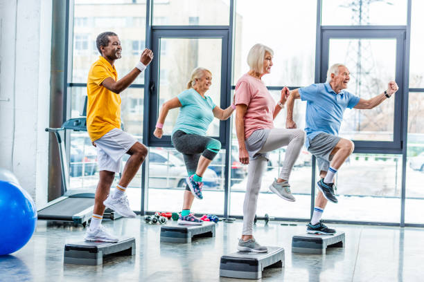 istock side view of multiethnic senior athletes synchronous exercising on step platforms at gym 1088958560