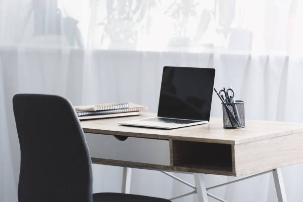 istock laptop with black screen on wooden table at workplace 1088960540