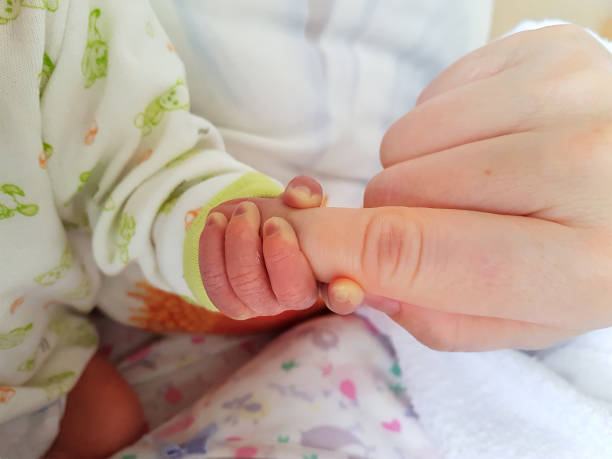 istock Baby hand wrapped around finger 1088962218