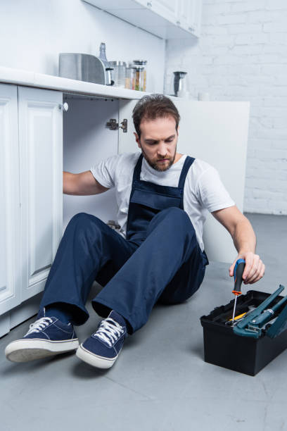 istock handyman in working overall fixing oven and taking tools from toolbox in kitchen 1088965112