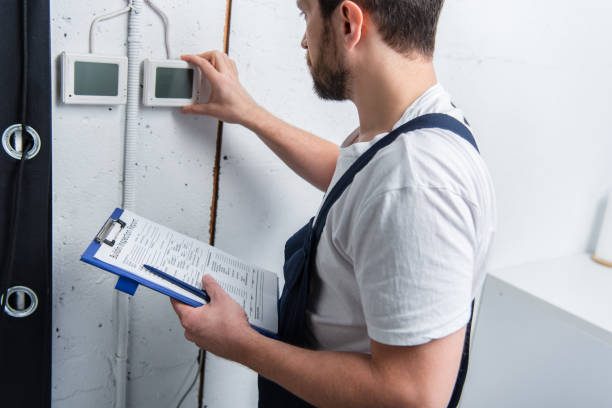 istock adult bearded electrician with clipboard checking electrical panel 1088965284