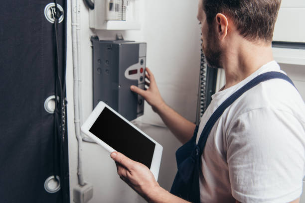 istock male bearded repairman with digital tablet checking electric box 1088965450