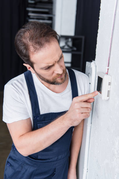 istock focused adult male handyman checking electrical panel 1088965684