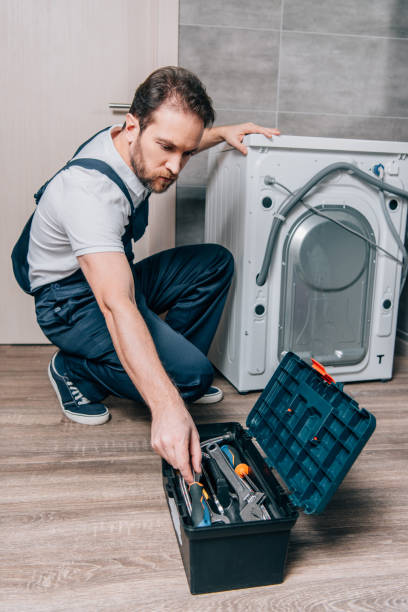 istock craftsman taking tools from toolbox while repairing washing machine in bathroom 1088966834