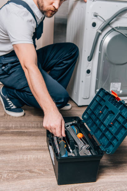 istock cropped shot of craftsman taking tools from toolbox while repairing washing machine in bathroom 1088966852