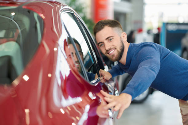 istock Brunette man with beard coming to salon and choosing auto. 1088967138