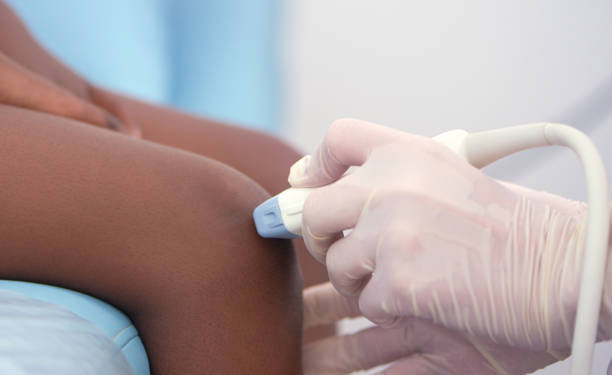 istock Doctor examining knee for ultrasound diagnostics. 1088967228