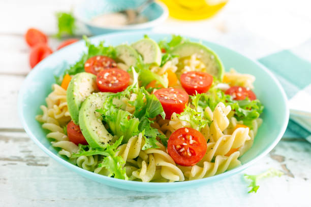 istock Pasta salad with avocado, fresh tomato, pepper and lettuce, top view 1088967510