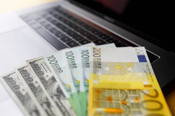 istock Background with american dollar and euro bills. 1088969596
