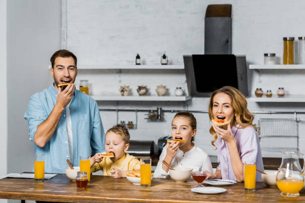 istock happy family eating toasts with jam at table in kitchen 1088971304