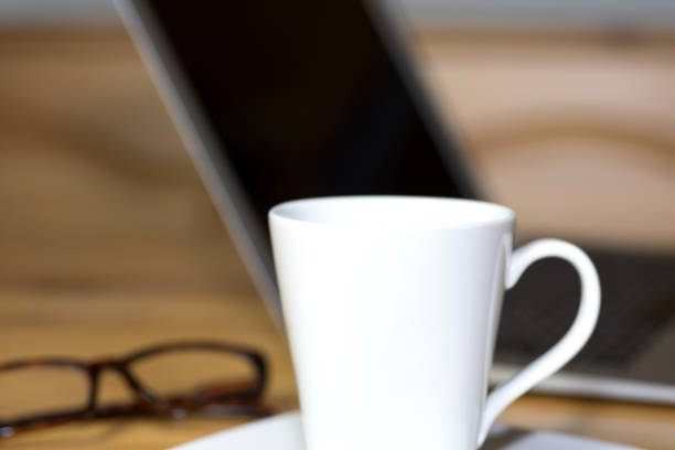 istock A cup of coffee, reading glasses and a computer in the office 1088985226