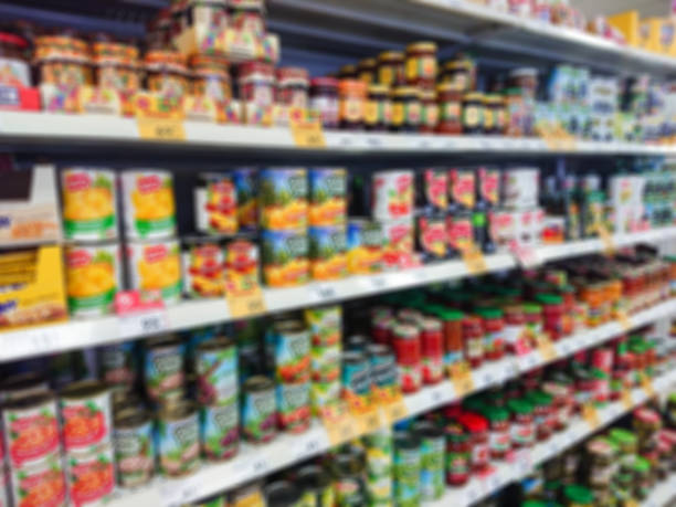Blurred abstract image. Goods on the shelf of a grocery store. Canned vegetables and fruit Blurred abstract image. Goods on the shelf of a grocery store. Canned vegetables and fruit. canned food stock pictures, royalty-free photos & images
