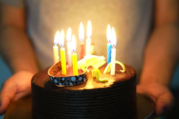 istock birthday chocolate cake on human hand 1088998058