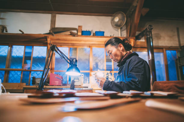 istock Asian man making craft from wood 1088998120
