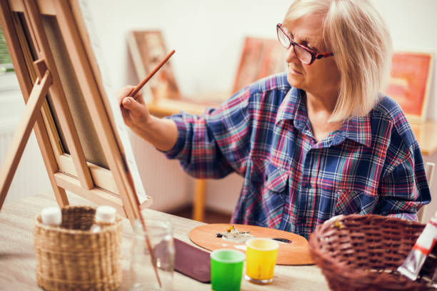 istock Senior woman painting 1088998334