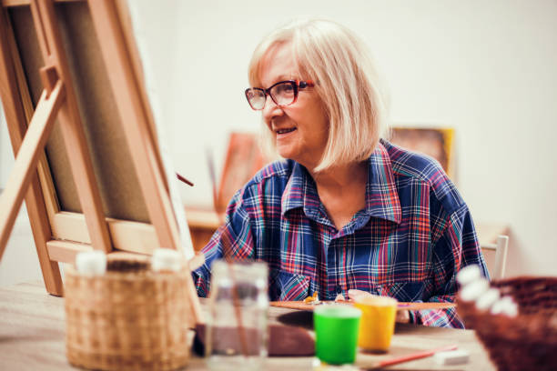 istock Senior woman painting 1088998732