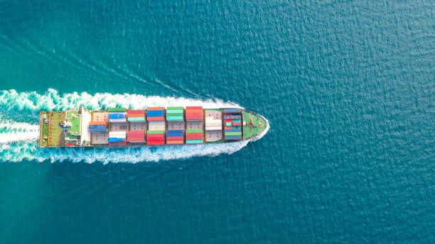 istock Container ship in export and import business logistics and transportation. Cargo and container box shipping to harbor by crane. Water transport International. Aerial view and top view. 1088998744