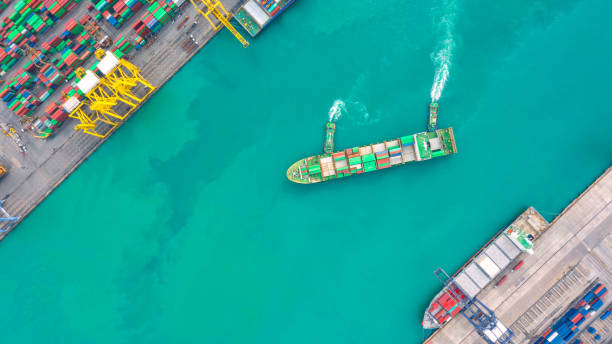 istock Container ship in export and import business logistics and transportation. Cargo and container box shipping to harbor by crane. Water transport International. Aerial view and top view. 1088998762